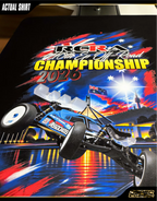 Black short-sleeve t-shirt shown from the rear with a large racing graphic print. The graphic features a blue and white off-road buggy, the text 'RCRA 2026', and Australian flag elements in red, white, and blue.